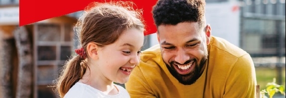 A man and a little girl smiling