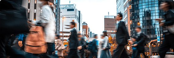Photo of a crowd of people walking to work downtown