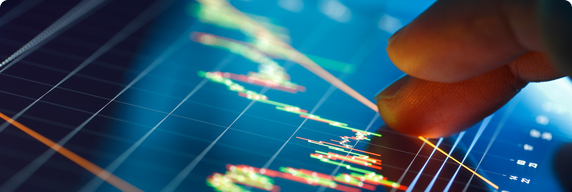 Picture of a screen with graphs and a finger pointing at the screen