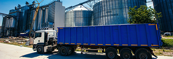 Photo of a truck in front of an agricultural crop processing plant