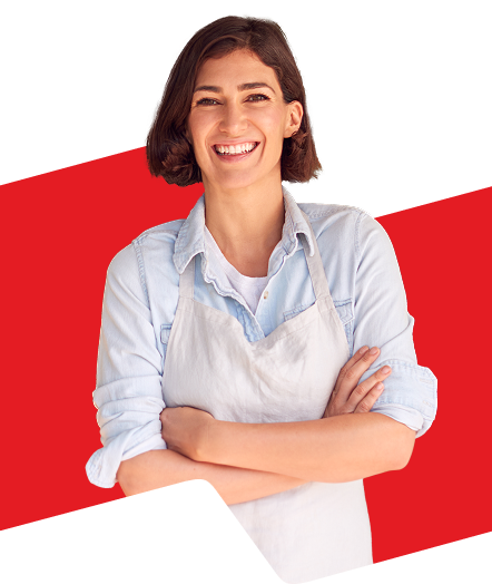 A smiling person wearing an apron. 