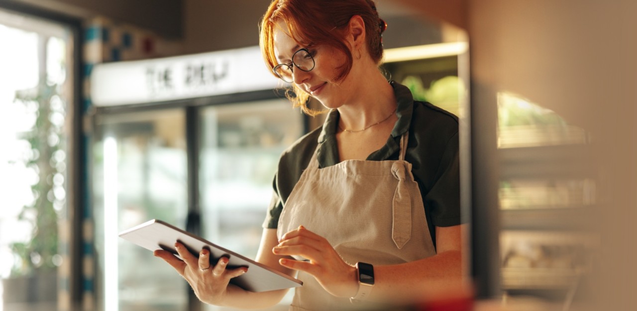 Photo of a business owner making an Interac e-Transfer on their tablet