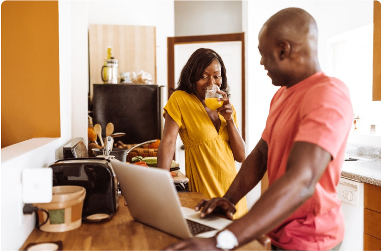 Photo of a couple with a laptop looking at tips on fraud prevention