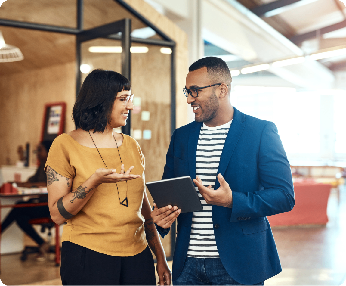 Photo of two people talking in a warehouse 