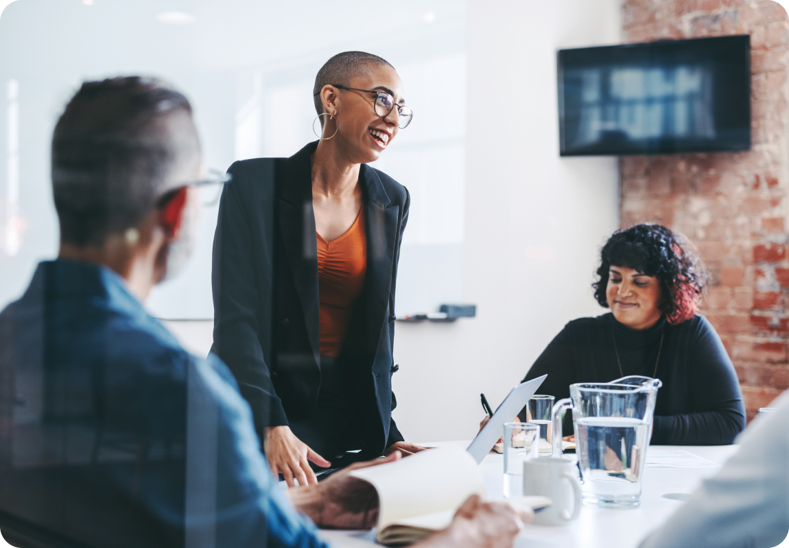 Photo of a group of people working in a conference room