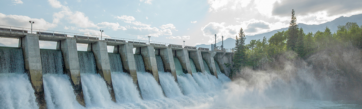 Image of a large dam with water flowing down its sides.