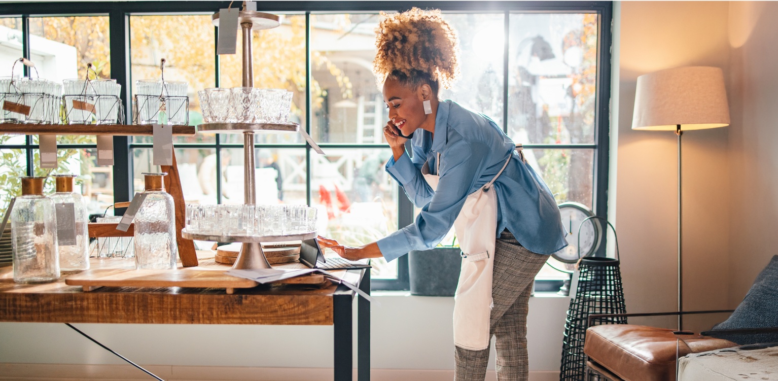 Photo of a self-employed worker in a restaurant looking at their account online 