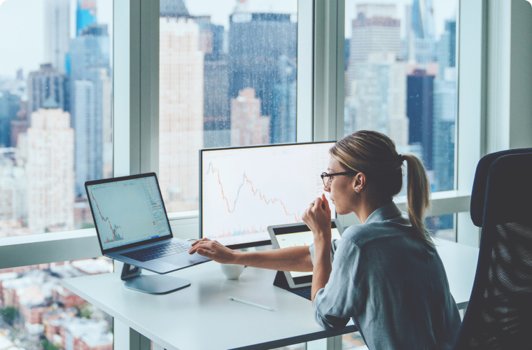 Photo of a person working at their computer in a downtown office  