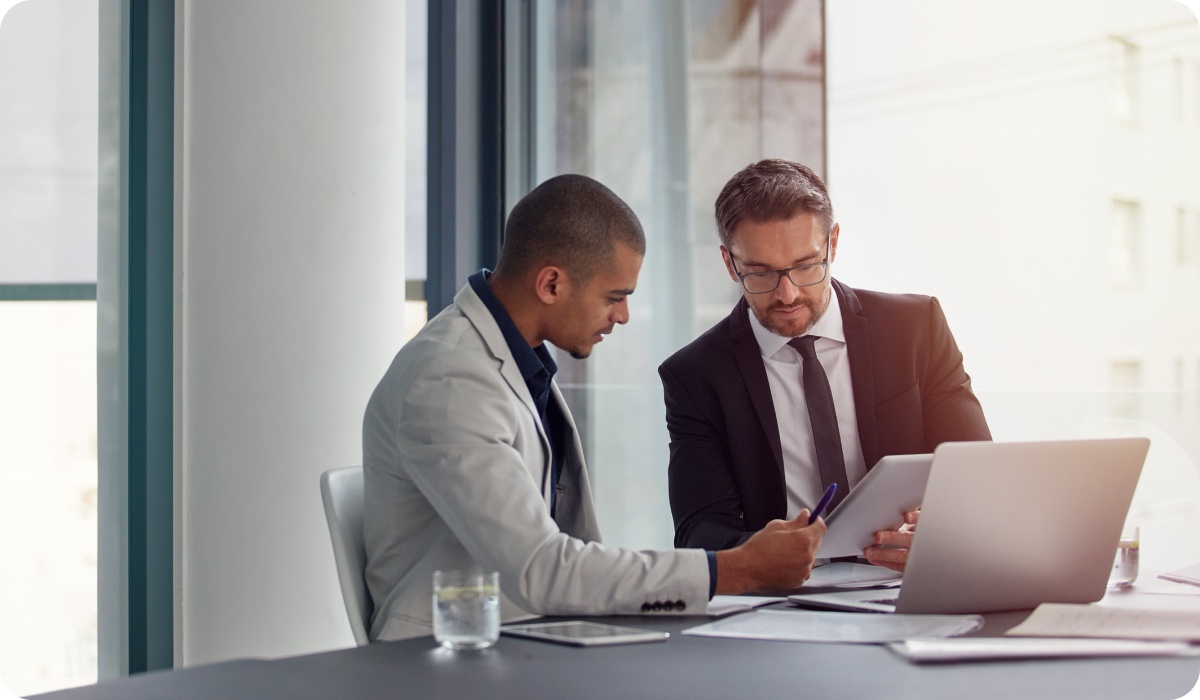 Photo of two people looking at some documents in an office 