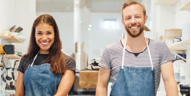 Photo of two people wearing aprons