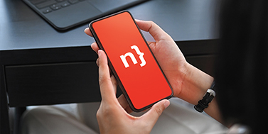 Photo of a pair of hands holding a cellphone displaying the Nethris logo
