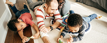 Young family playing in the living room