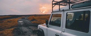 Jeep driving through rugged terrain