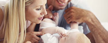 Couple cuddling their baby