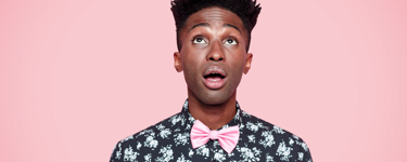 Young man in a bowtie looking up in surprise
