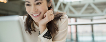 Young professional women smiling at her computer screen