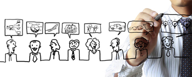 Man wearing a tie draws cartoons on a glass surface
