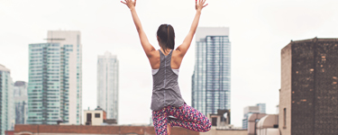 Woman doing yoga on a rooftop