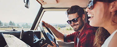 Man and woman in a car on vacation