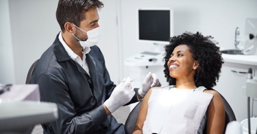 Photo of a doctor administering a vaccine to a young woman