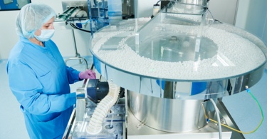 Photo of a lab technician conducting research