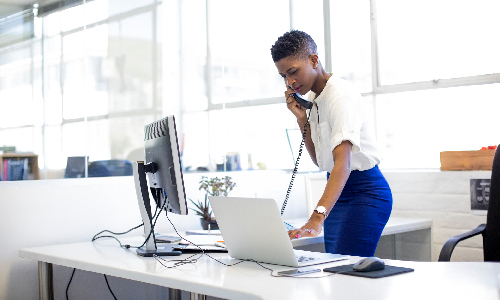 Young woman on the phone at her desk