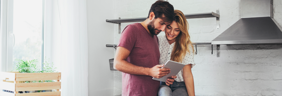 Couple planning their trip looking at a tablet