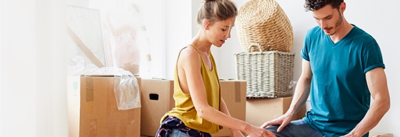 Two young adults moving into their apartment
