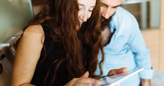 Smiling couple looking at a tablet