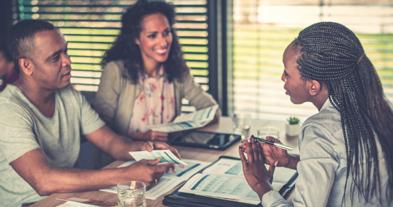 Young couple talking with banking advisor