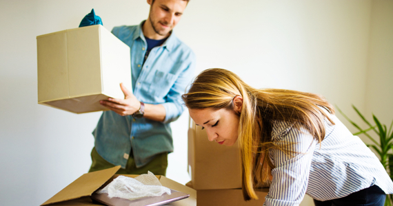 Young couple unpacks boxes