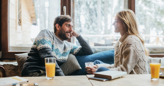 Happy couple talking on a couch