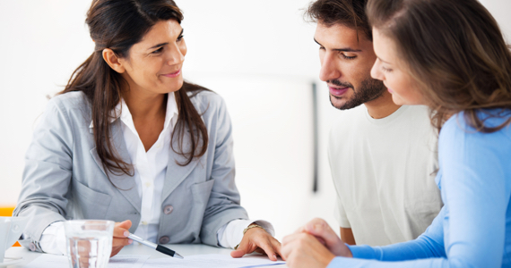 Woman shows a document to a young couple