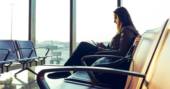 Woman at airport looking at her phone