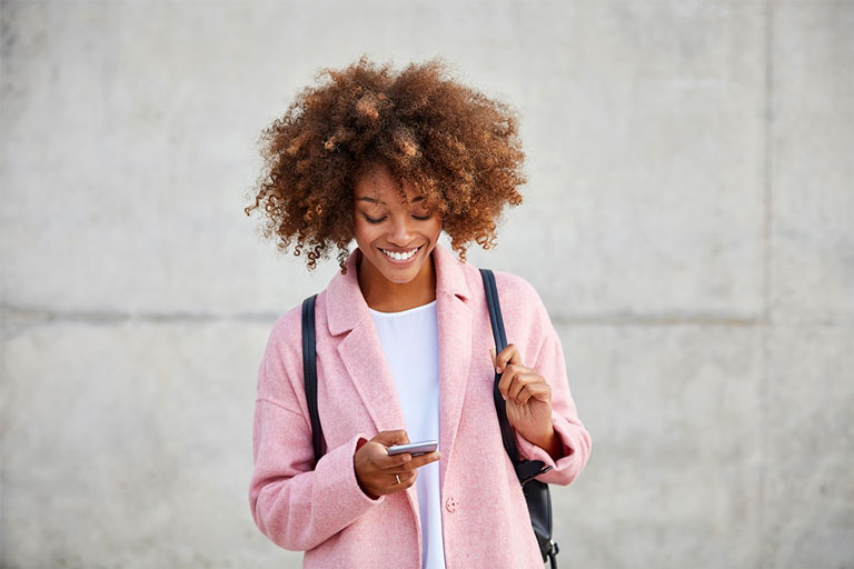 Woman walking with her mobile
