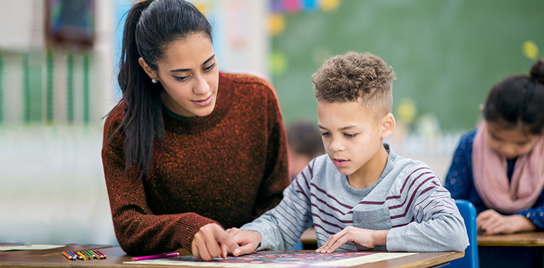 A teacher doing homework with their student.