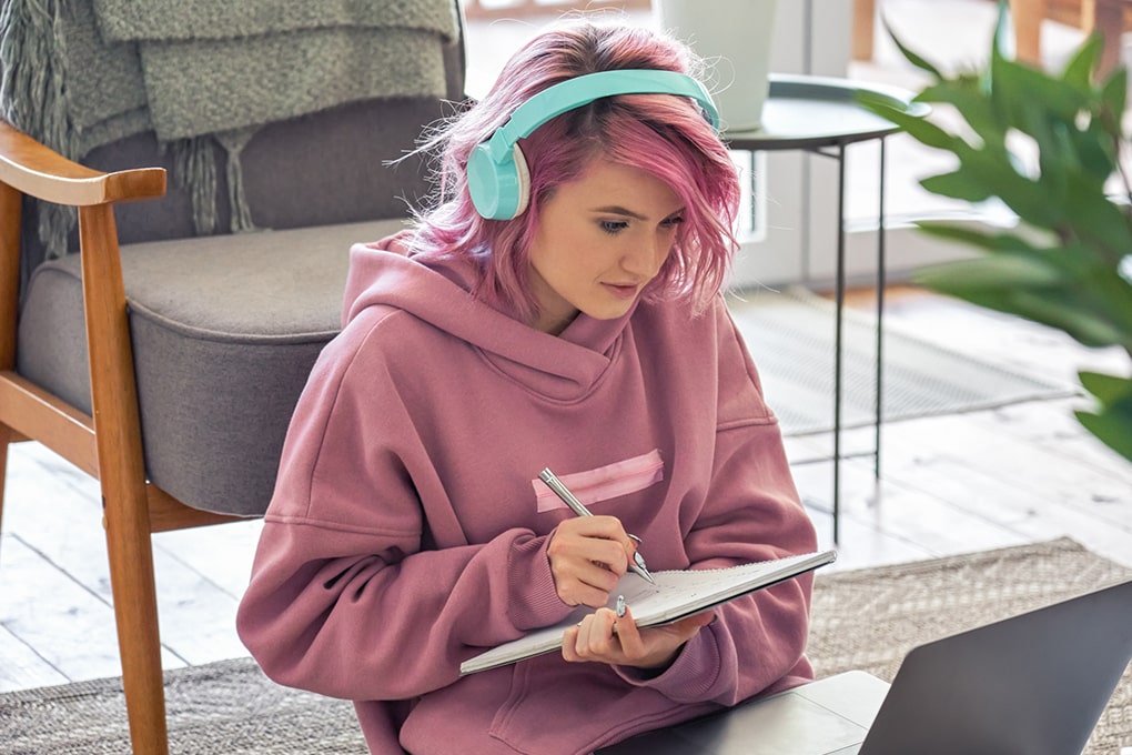Young hipster with headphones on a laptop 