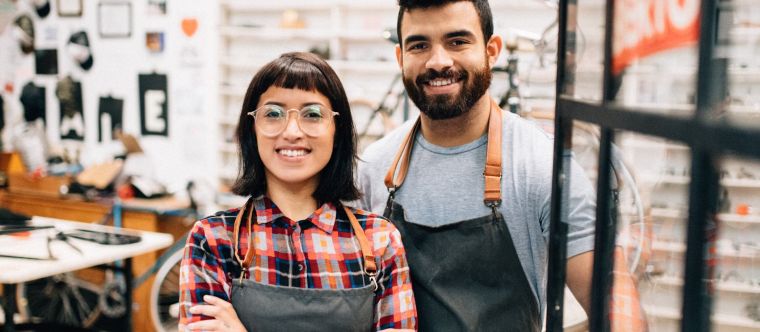 Photo of a couple smiling in a workshop