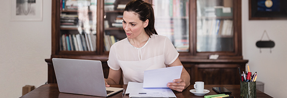 Photo of a woman working on a computer in her office 