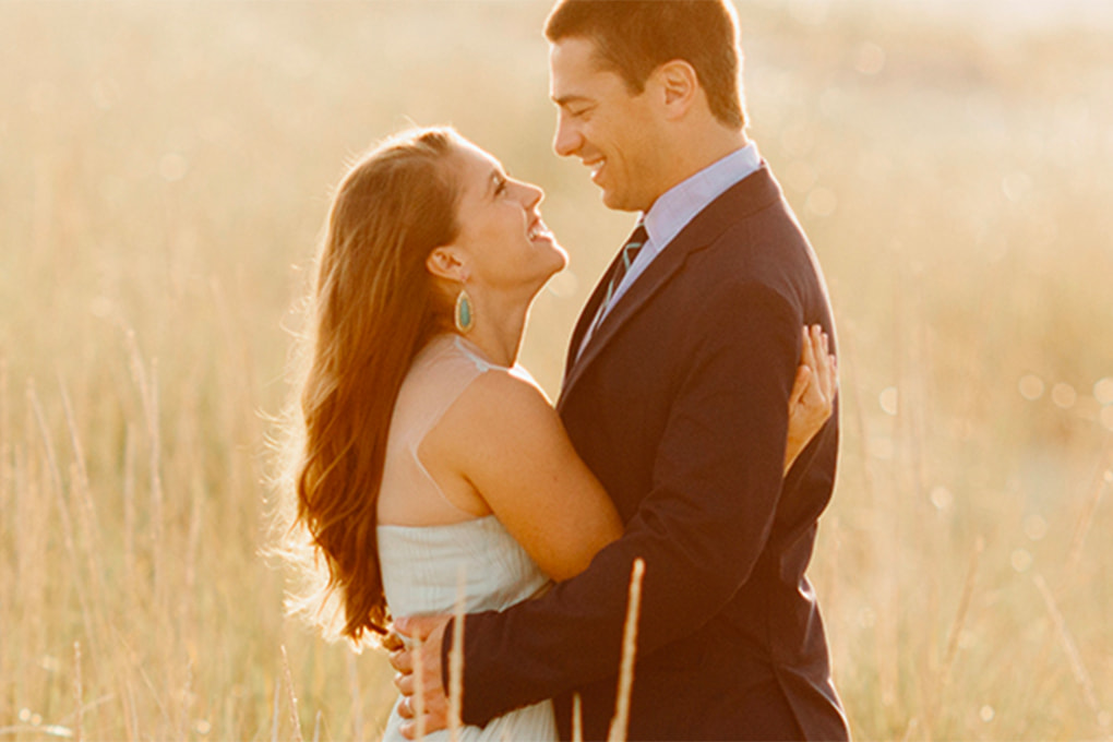 Couple holding each other in a wheat field