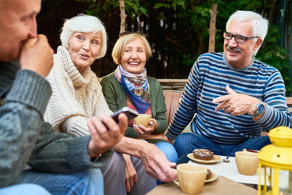 Photo of a group of people talking and smiling