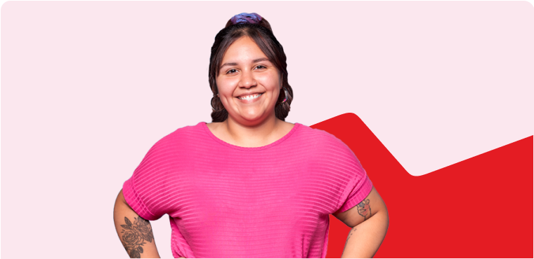 Photo of a woman smiling and wearing a pink shirt 