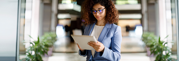 Young woman reading on a tablet