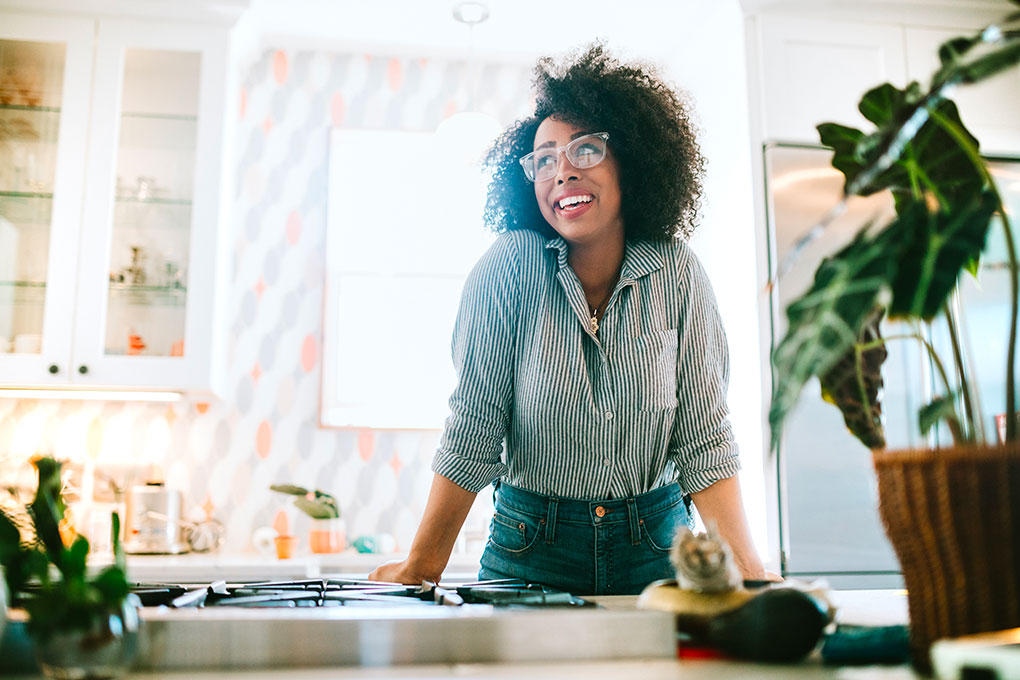  Photo of a woman smiling in a kitchen