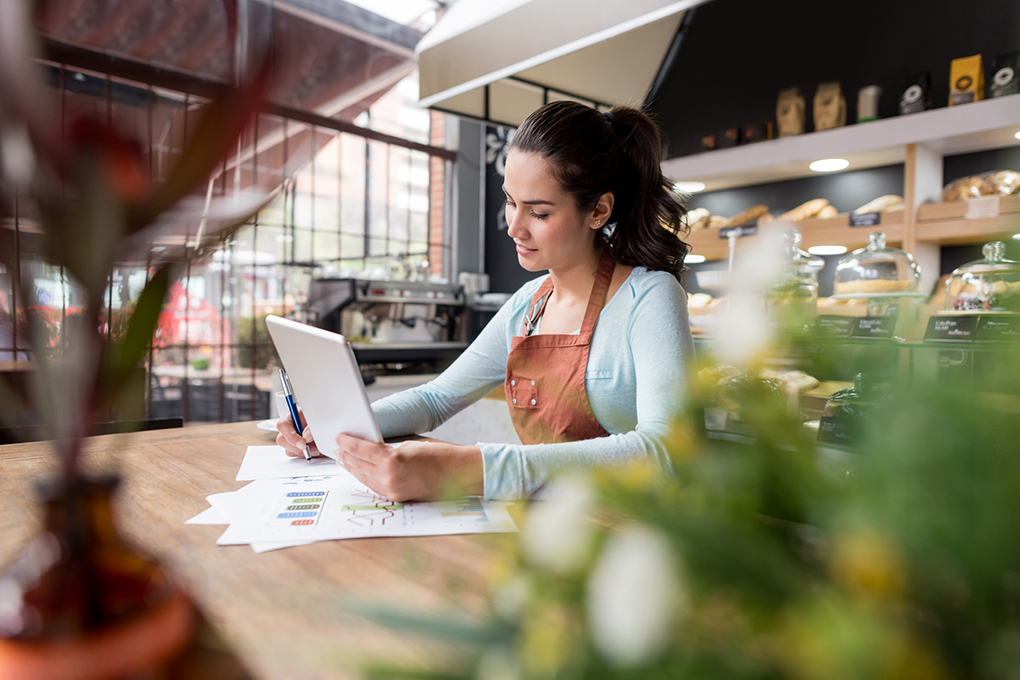 A woman does the accounting for her business.