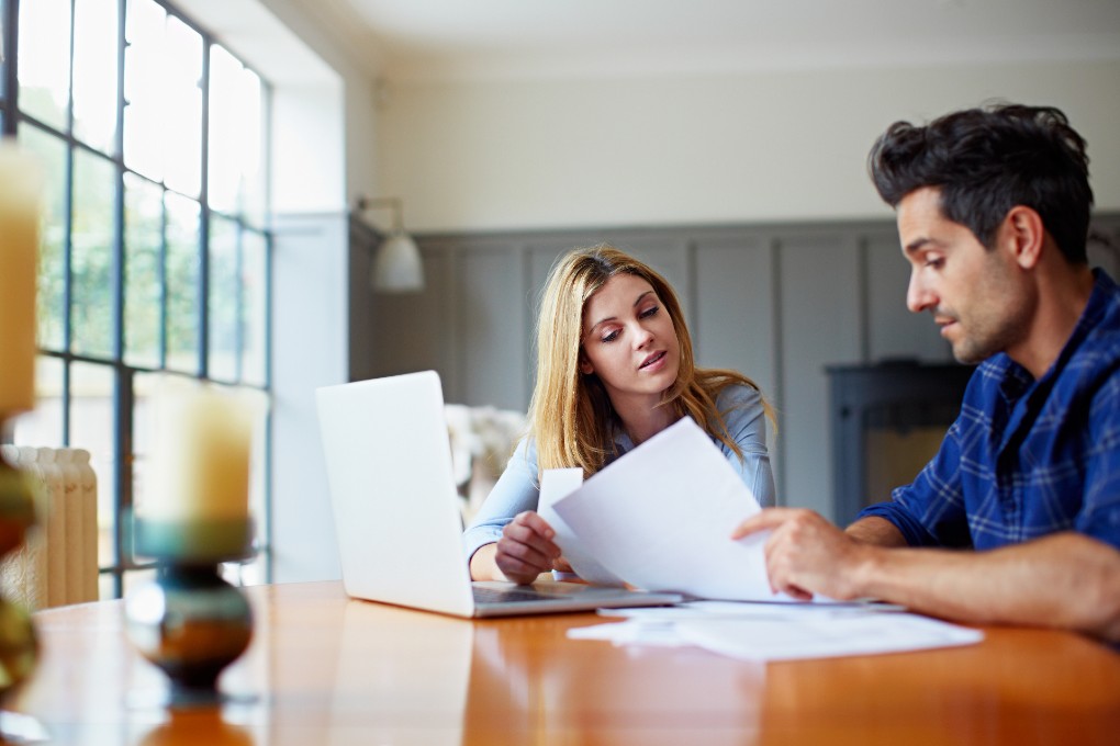 Young couple looking at deductible interest and  financial fees 