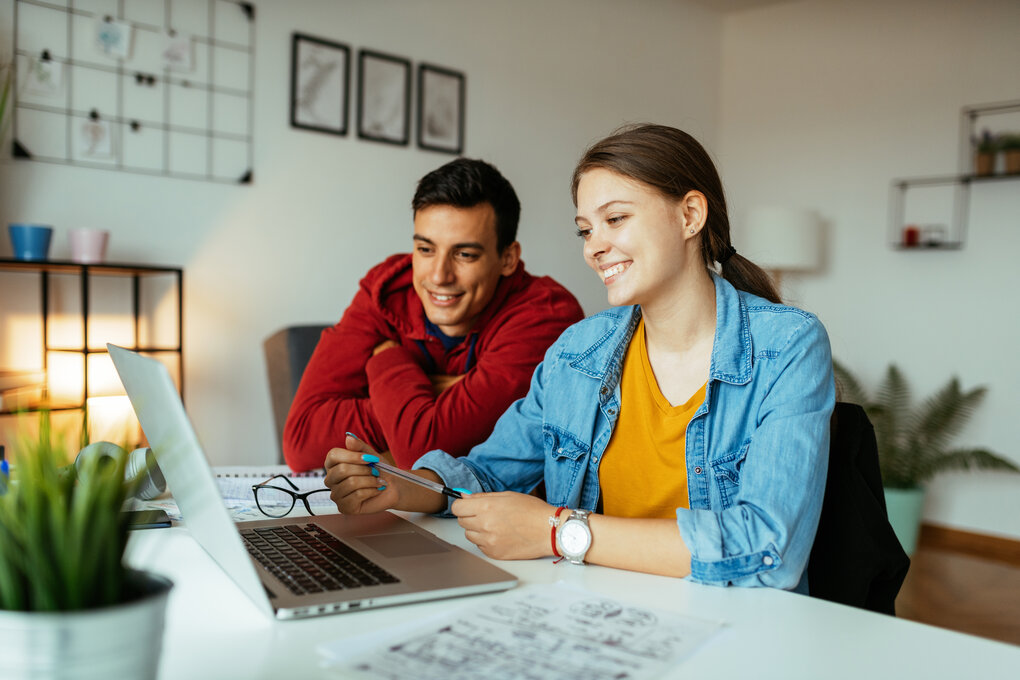 A couple sitting in front of a computer