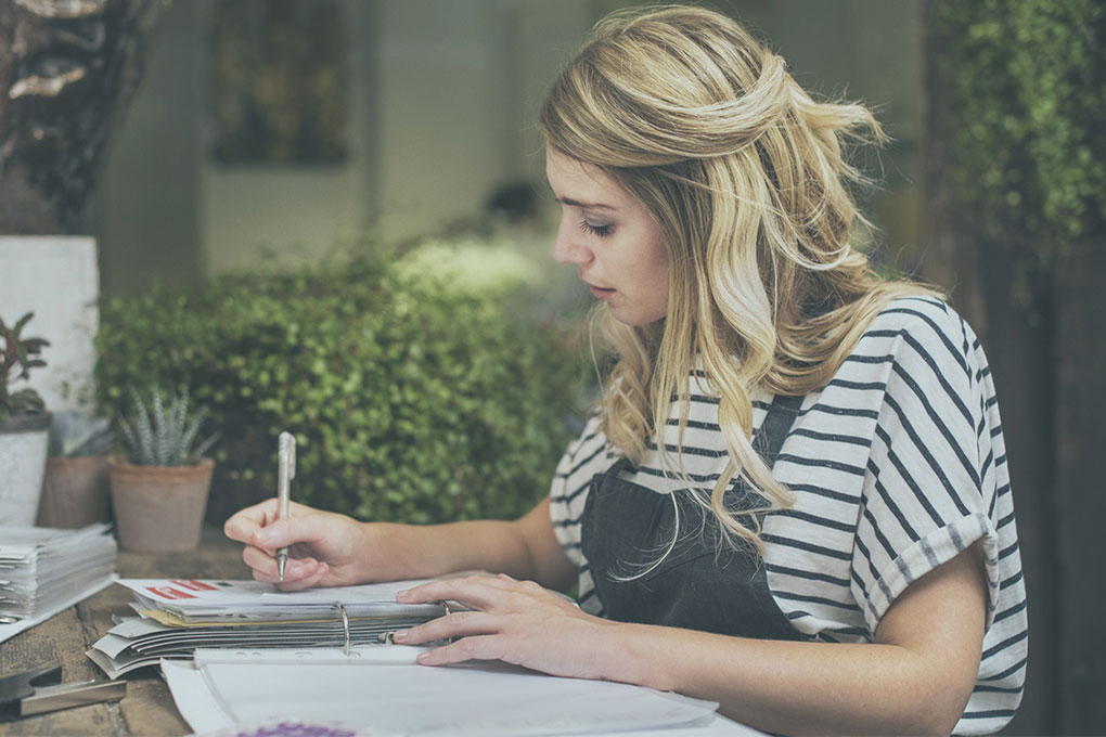 A self-employed woman calculates her hourly rate.