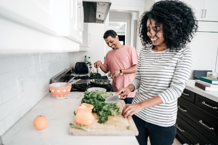 Woman cutting vegetables on cutting board