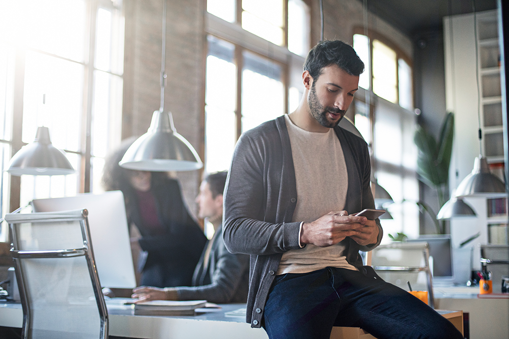 Photo of a man using his cell phone 